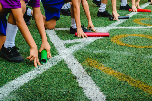 Children lining up for a relay race.
