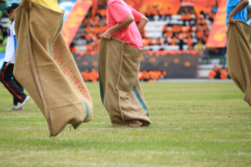 Children taking part in a sack race.
