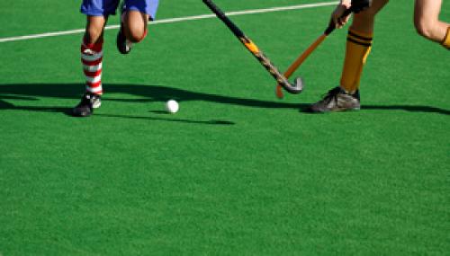 Two people playing hockey.