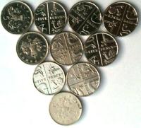 A triangle made of five pence pieces. The base is made of 4 coins, the next layer is made of 3 coins, the next layer is made of two coins, and the final layer is made of one coin.