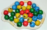 A selection of coloured balls with numbers from 1 to 9 written on them, with a rope around them.