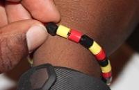 A bracelet of three alternating colours: red, black and yellow.
