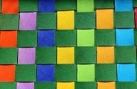 Different colours of paper weaved together.