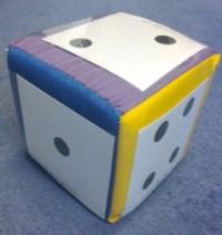 A large soft dice, showing faces with one, two and four dots.