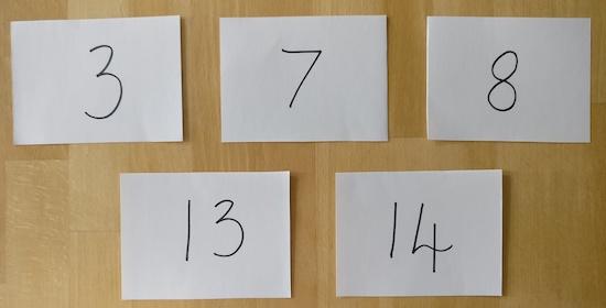 Five envelopes, each one showing one of the numbers 3, 7, 8, 13, 14.