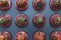 Chocolate cupcakes with sprinkles.