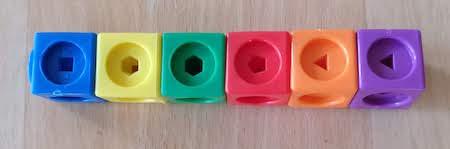 A stick made of a blue, yellow, green, red, orange and purple cube from left to right.