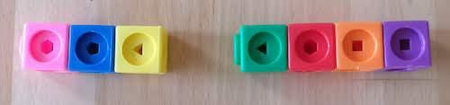 The stick on the left is made of a pink, a blue and a yellow cube. The stick on the right is made of a green, a red, an orange and a purple cube.