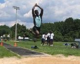 A man doing a long jump.