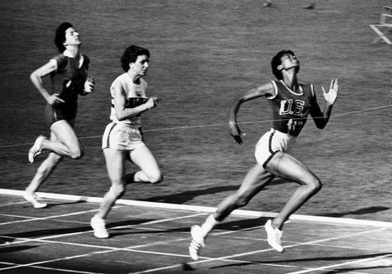 Wilma Rudolph crossing the finish line in a sprint.