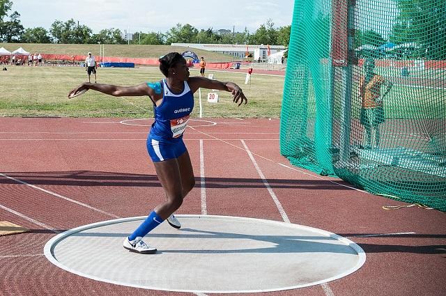 A woman throwing a discus in a sporting event.