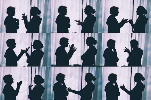 Different silhouette photographs of the same two people talking.