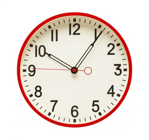 A red wall clock.