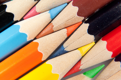 Two rows of coloured pencils, with the tips slotted together.