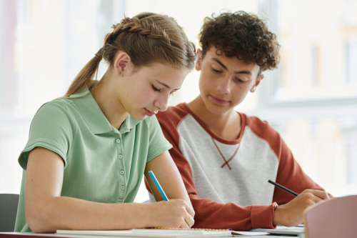 A boy and a girl working collaboratively.
