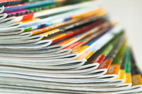 A stack of colourful magazines, fanned out.