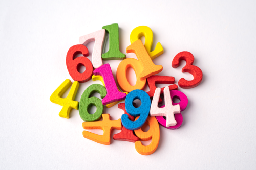 A pile of colourful foam numbers from 0 to 9.
