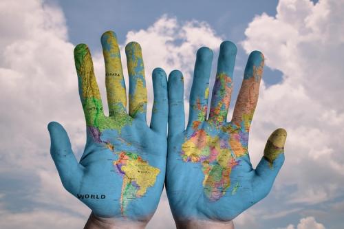 Hands showing a map of the globe on the palms.