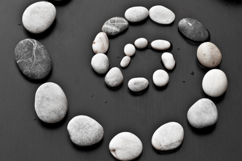 A grey spiral made of stones.